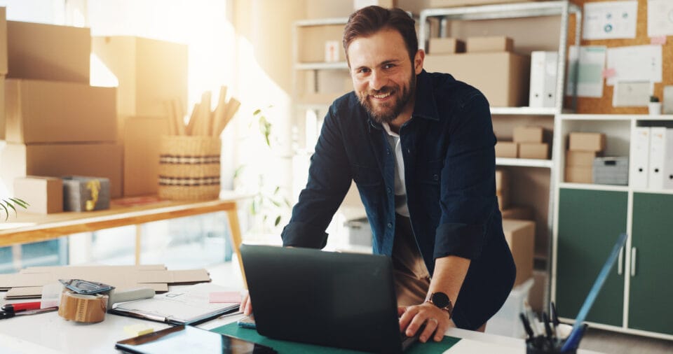 Man, portrait and laptop in small business for logistics, supply chain or distribution. Entrepreneur, distributor and technology in storage for export, startup growth or stock inventory for ecommerce